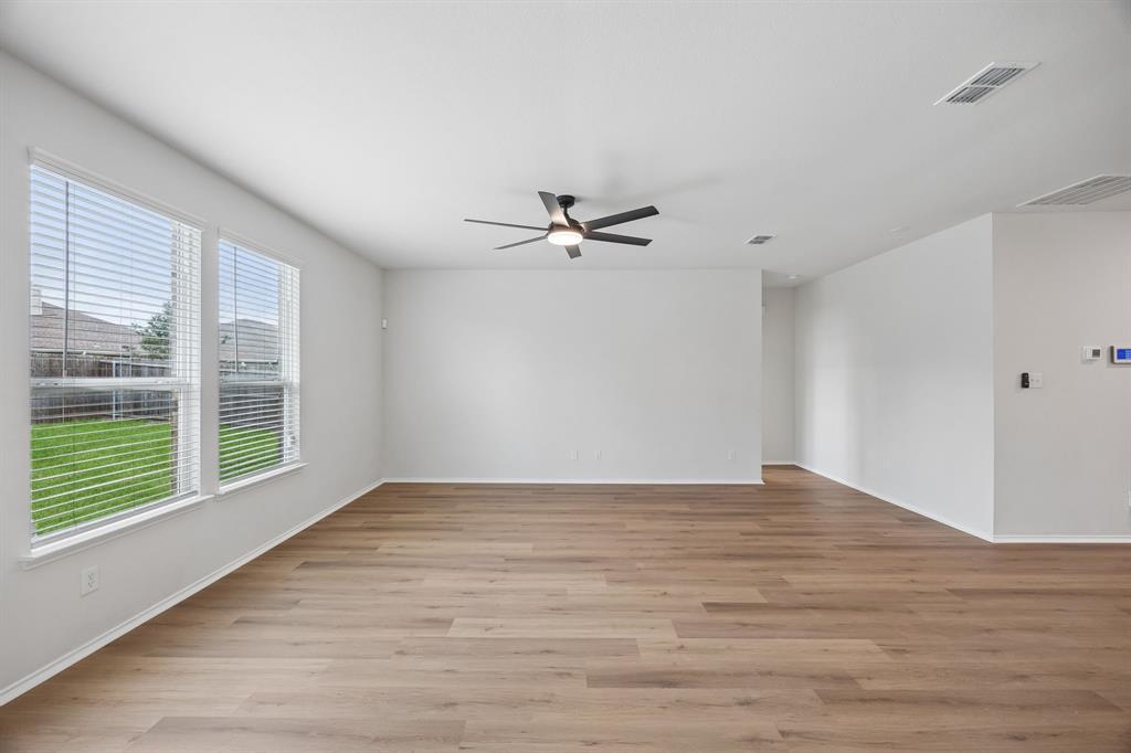 1006 Voca Dr. Forney, TX 75126 - Photo 11 of 26 a view of an empty room with wooden floor and a window