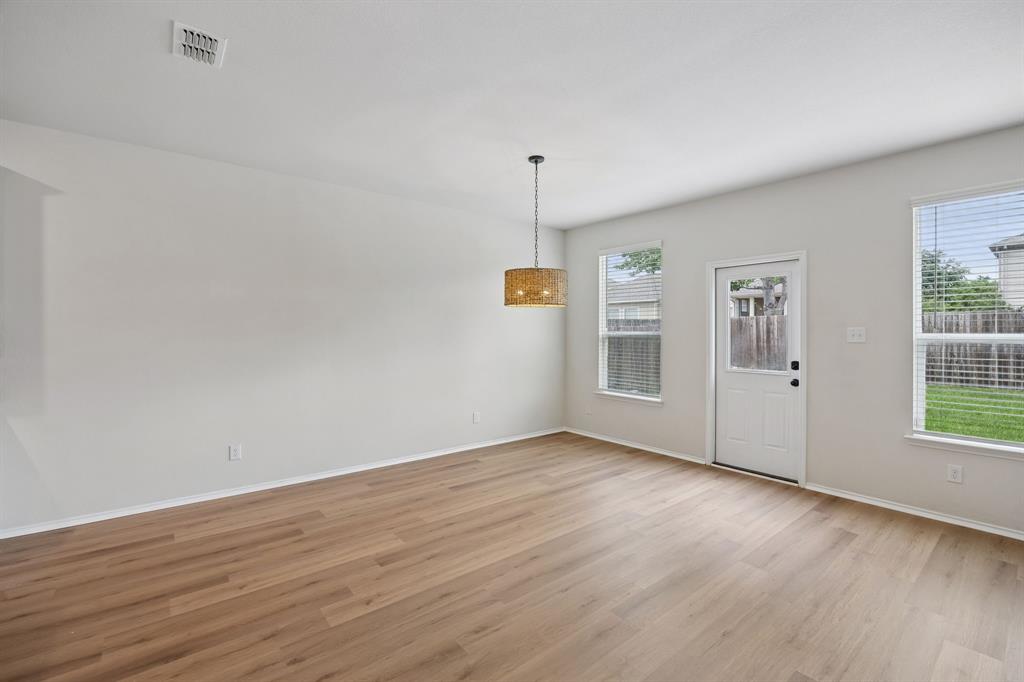 1006 Voca Dr. Forney, TX 75126 - Photo 12 of 26 wooden floor in an empty room with a window