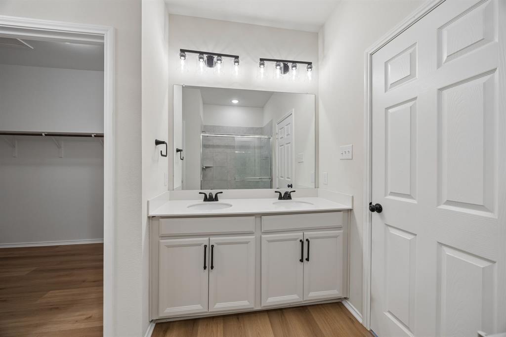 1006 Voca Dr. Forney, TX 75126 - Photo 15 of 26 a bathroom with a double vanity sink and mirror
