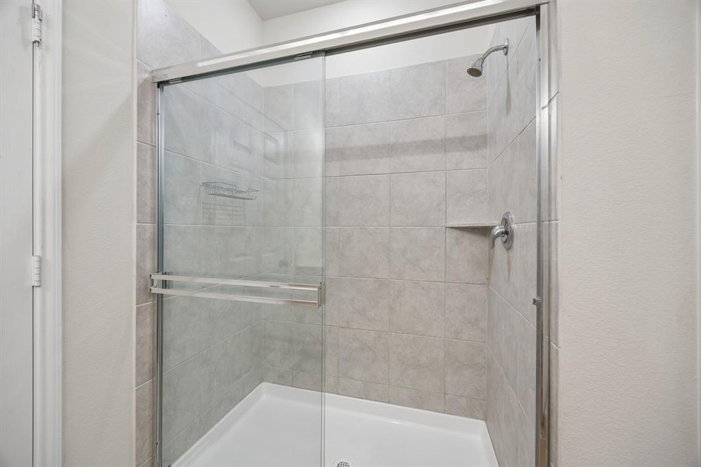 1006 Voca Dr. Forney, TX 75126 - Photo 17 of 26 a bathroom with a shower