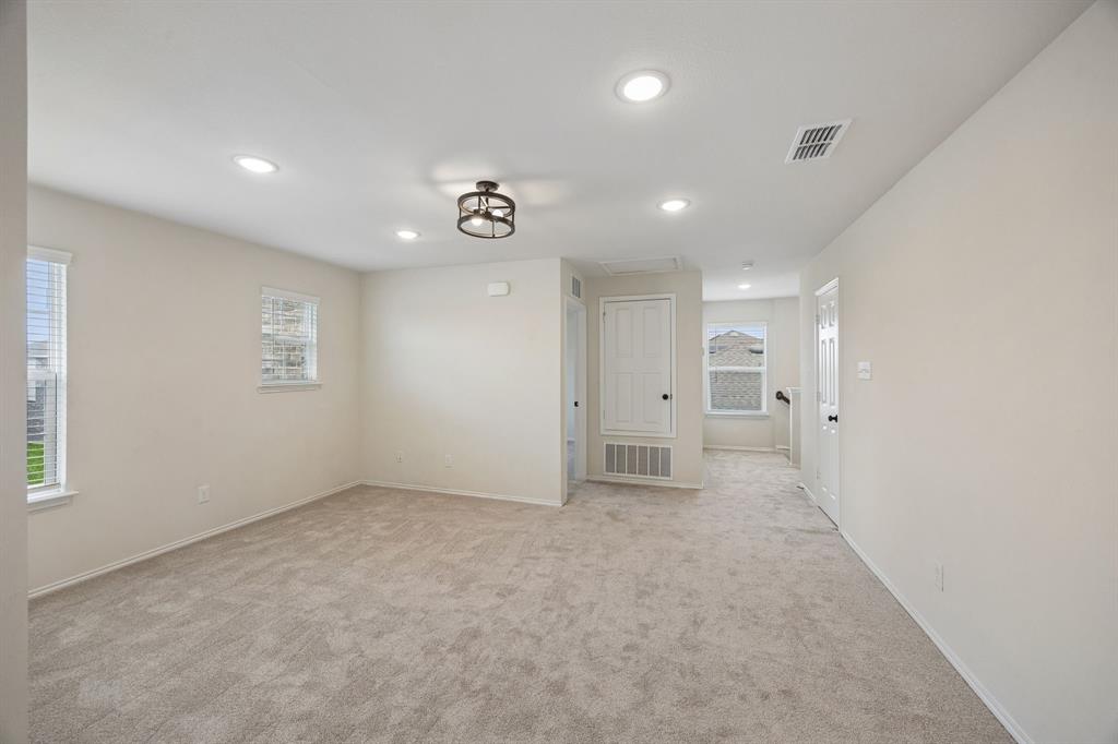 1006 Voca Dr. Forney, TX 75126 - Photo 20 of 26 an empty room with windows and entrance to other room