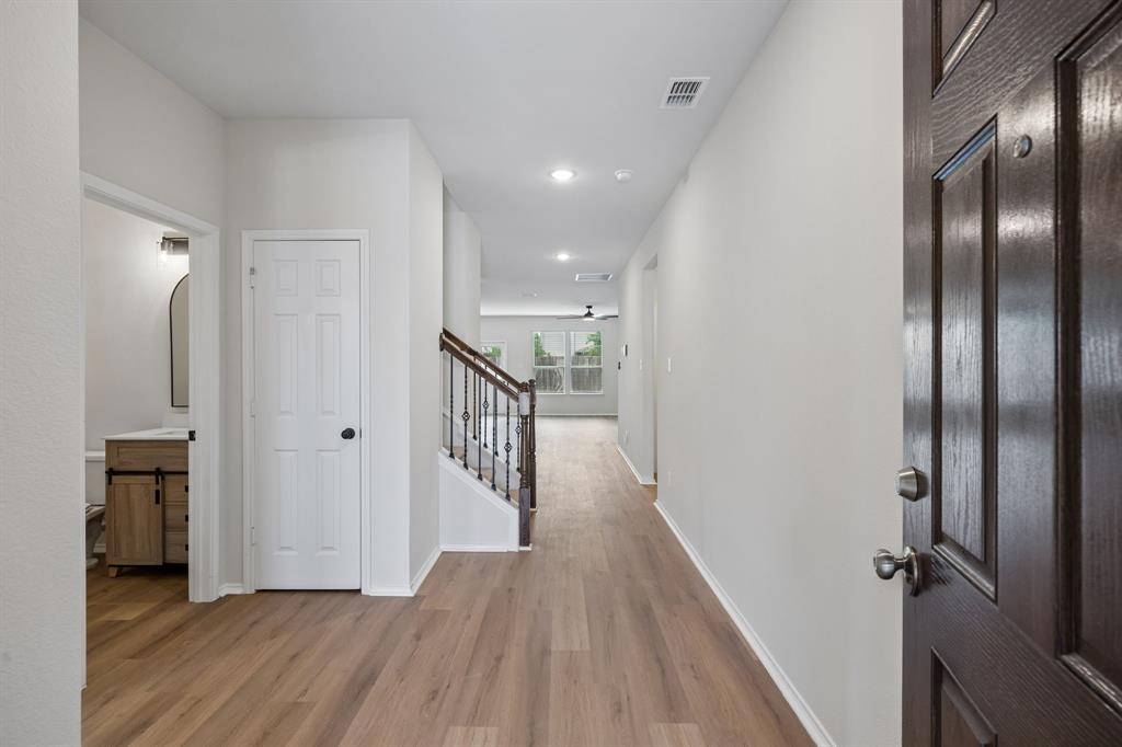 1006 Voca Dr. Forney, TX 75126 - Photo 2 of 26 a view of a hallway with wooden floor
