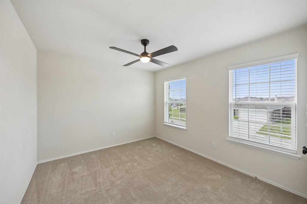 1006 Voca Dr. Forney, TX 75126 - Photo 22 of 26 a view of a livingroom with a ceiling fan and window