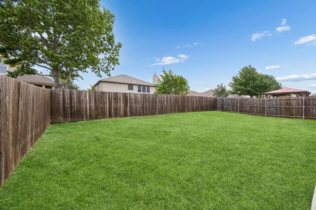 1006 Voca Dr. Forney, TX 75126 - Photo 26 of 26 a view of a backyard with a garden