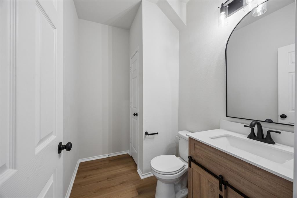 1006 Voca Dr. Forney, TX 75126 - Photo 4 of 26 a bathroom with a sink and a toilet