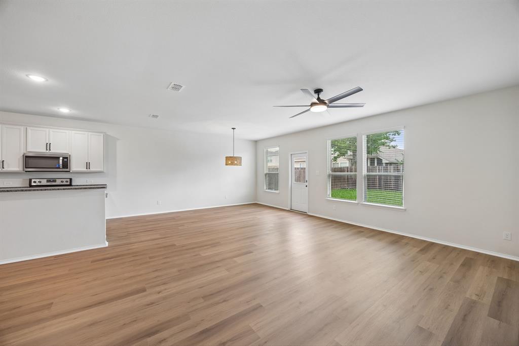 1006 Voca Dr. Forney, TX 75126 - Photo 10 of 26 a view of an empty room with wooden floor and a window