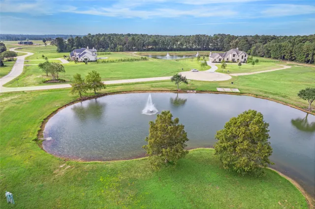 an aerial view of a golf course with a lake view