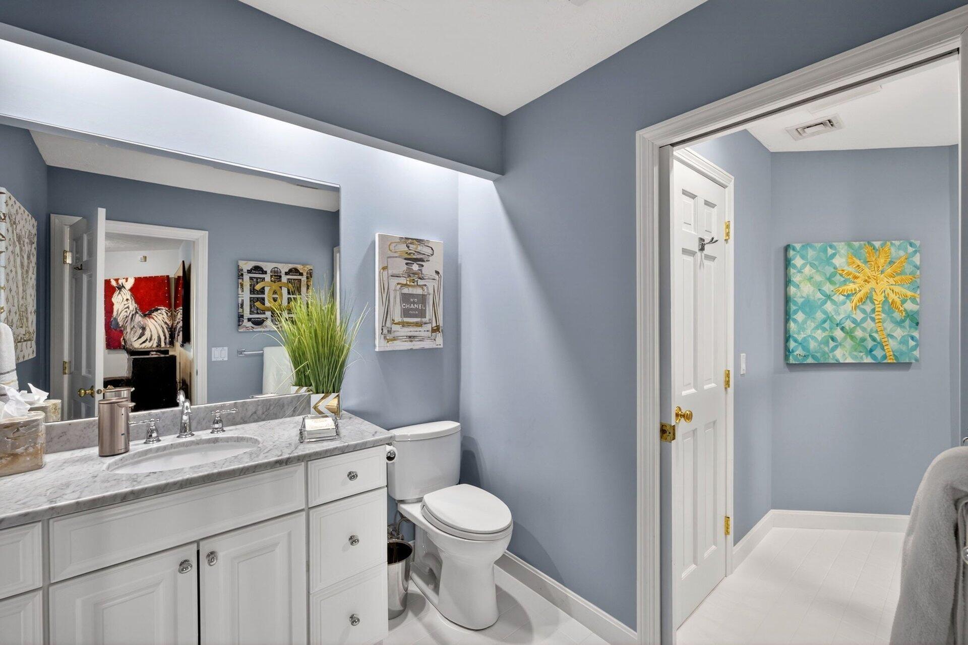 461 Wings Neck Road Pocasset, MA 02559 - Photo 34 of 42 a bathroom with a toilet sink and mirror