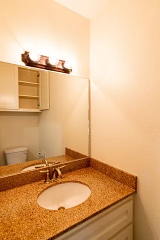 a white toilet sitting next to a shower