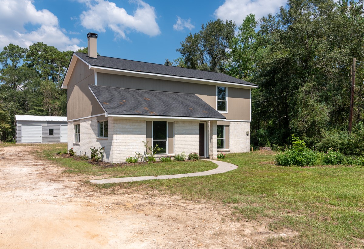 13087 Crystal Trail Conroe, TX 77306 - Photo 3 of 47 a front view of a house with a yard