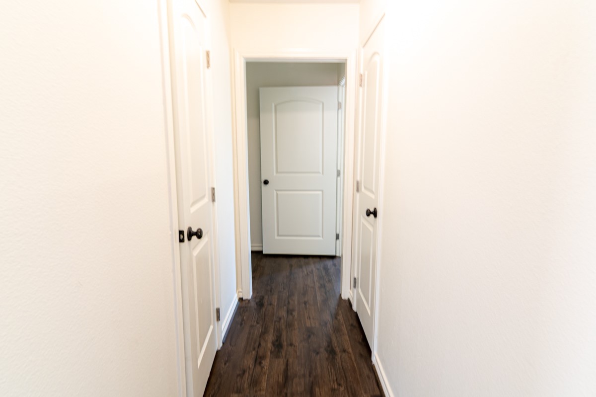 13087 Crystal Trail Conroe, TX 77306 - Photo 32 of 47 a view of a hallway with wooden floor