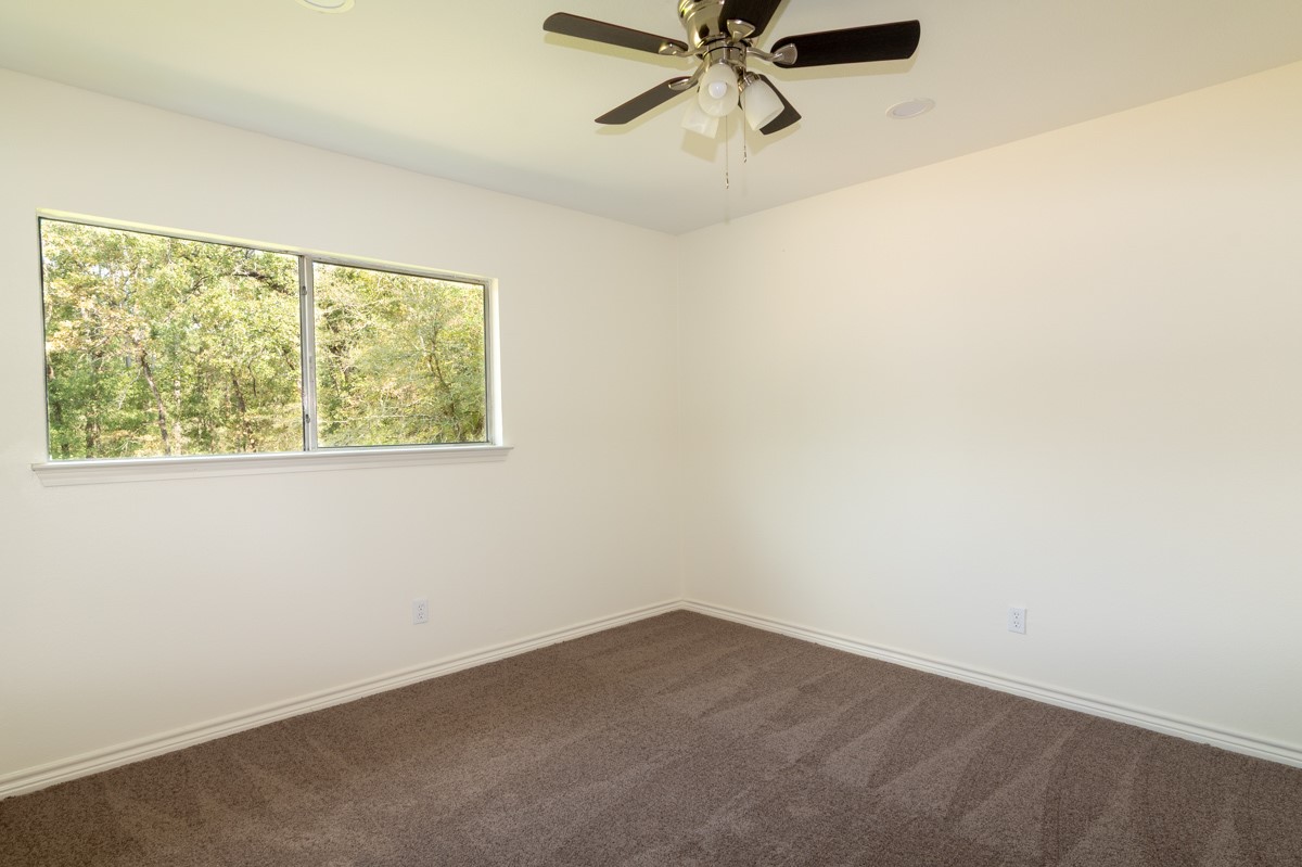 13087 Crystal Trail Conroe, TX 77306 - Photo 36 of 47 an empty room with a window and a fan