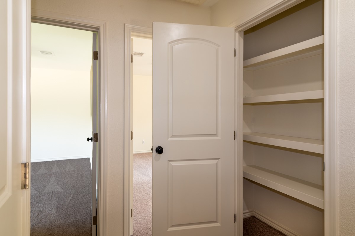 13087 Crystal Trail Conroe, TX 77306 - Photo 38 of 47 a view of walk in closet with empty racks