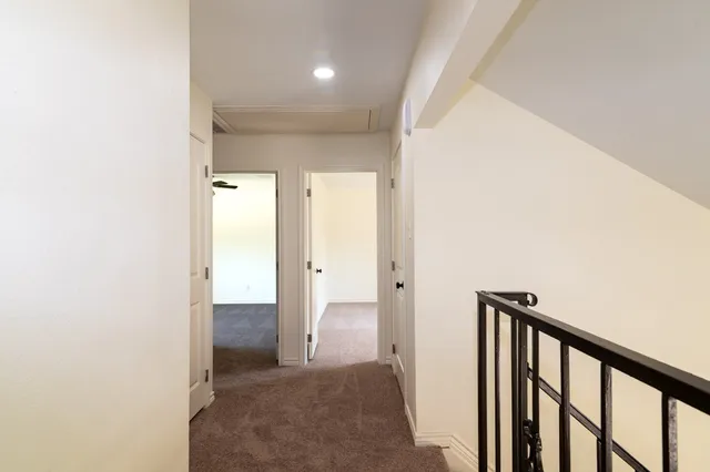 a view of a room with a window and a ceiling fan