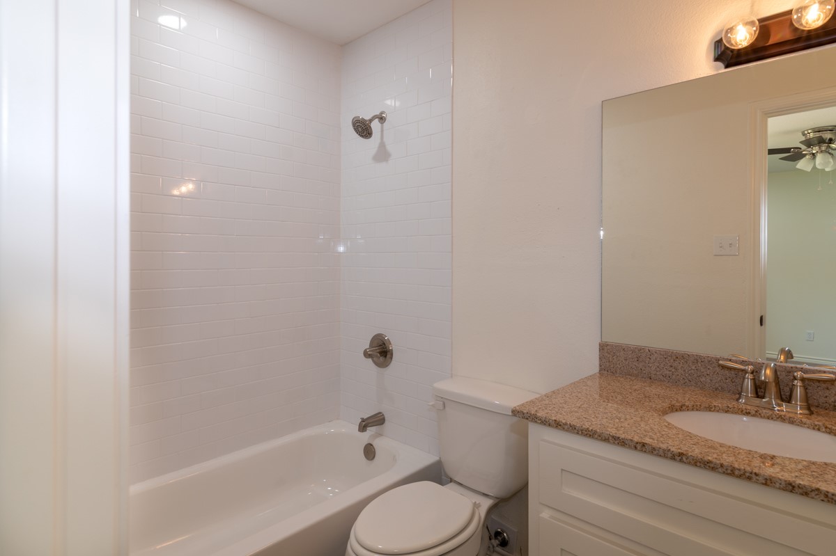 13087 Crystal Trail Conroe, TX 77306 - Photo 41 of 47 a bathroom with a granite countertop sink toilet and shower