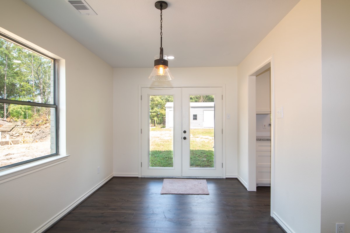 13087 Crystal Trail Conroe, TX 77306 - Photo 45 of 47 a view of an empty room with wooden floor and a window