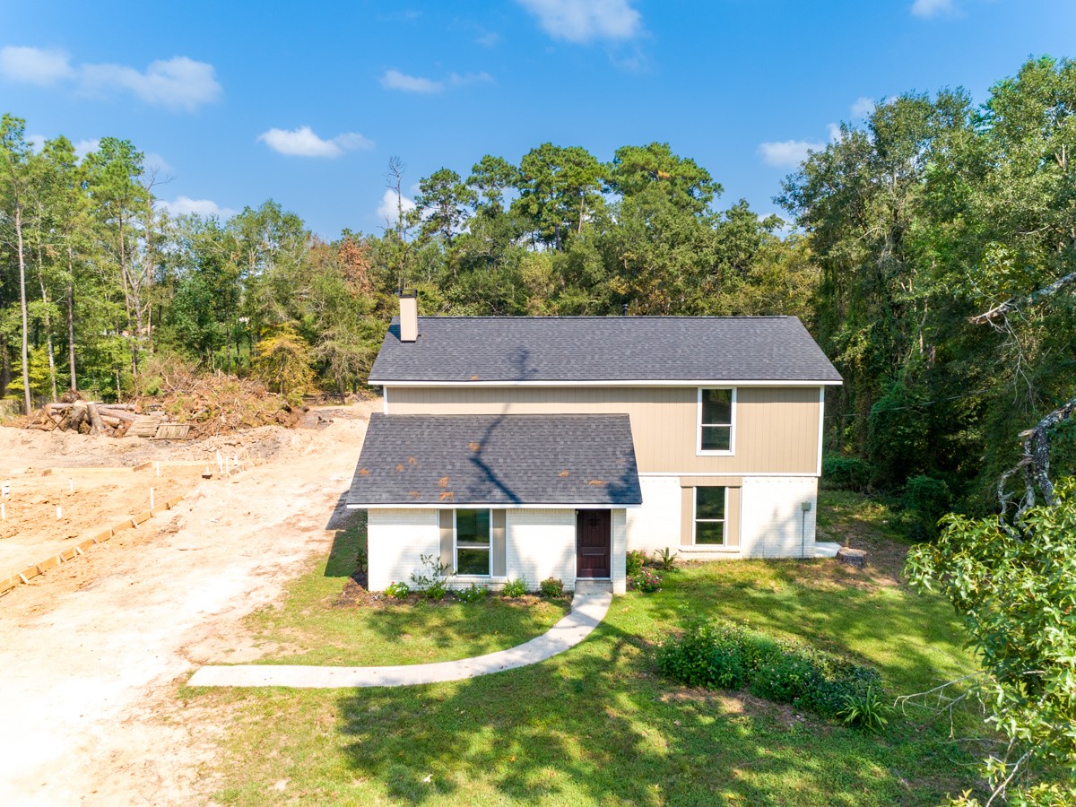 13087 Crystal Trail Conroe, TX 77306 - Photo 5 of 47 a front view of a house with a yard