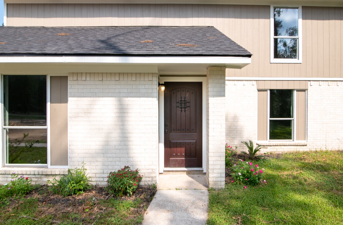 13087 Crystal Trail Conroe, TX 77306 - Photo 6 of 47 a front view of a house with a yard