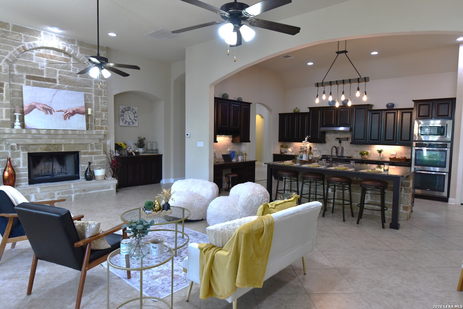 8907 Irving Hill Fair Oaks Ranch, TX 78015 - Photo 14 of 42 a living room with dining table and a fireplace