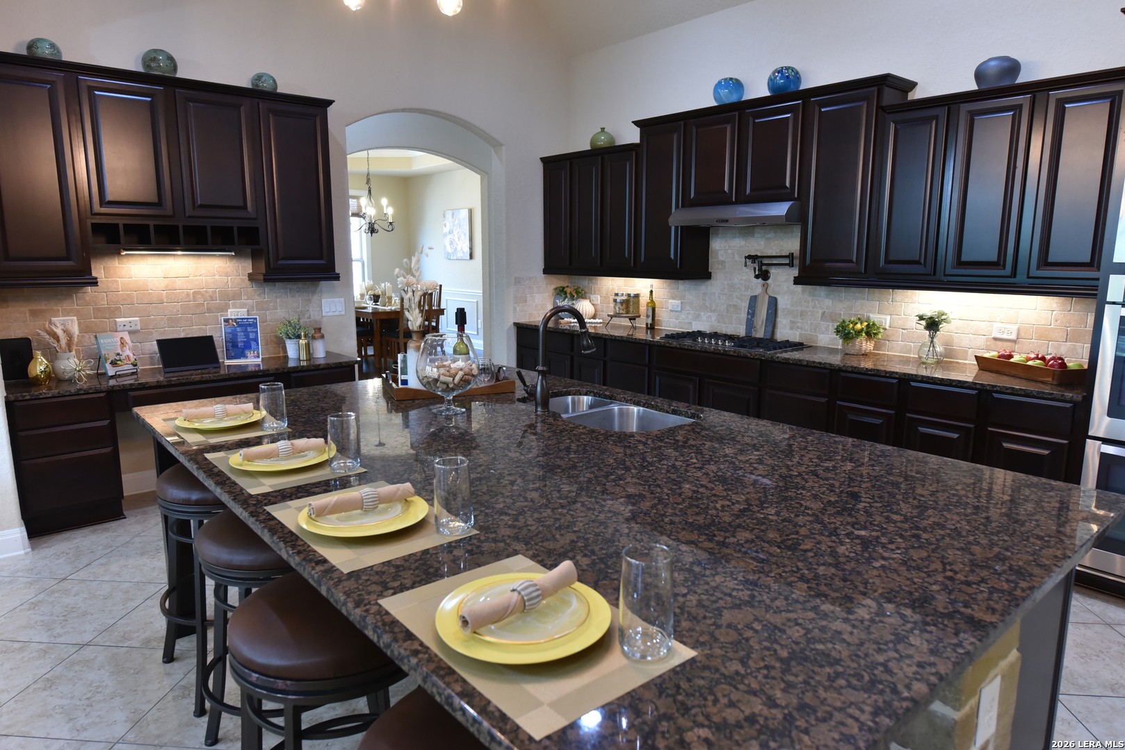8907 Irving Hill Fair Oaks Ranch, TX 78015 - Photo 17 of 42 a kitchen with a sink a stove and chairs