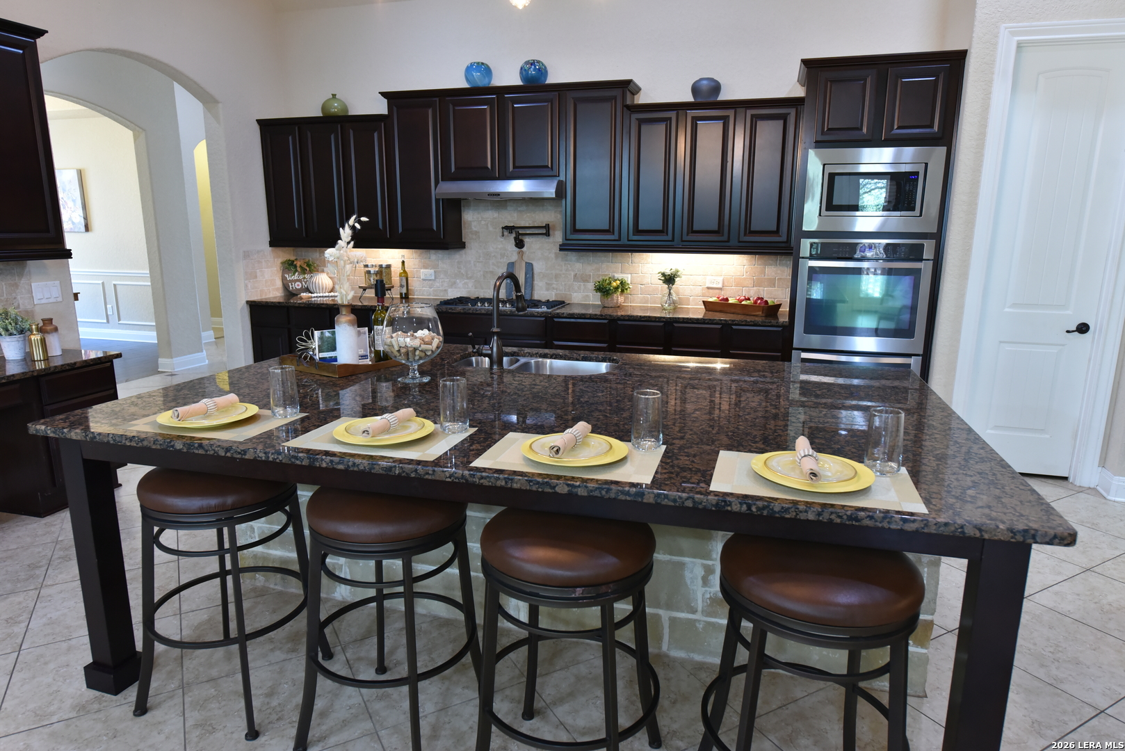 8907 Irving Hill Fair Oaks Ranch, TX 78015 - Photo 18 of 42 a kitchen with a dining table and chairs