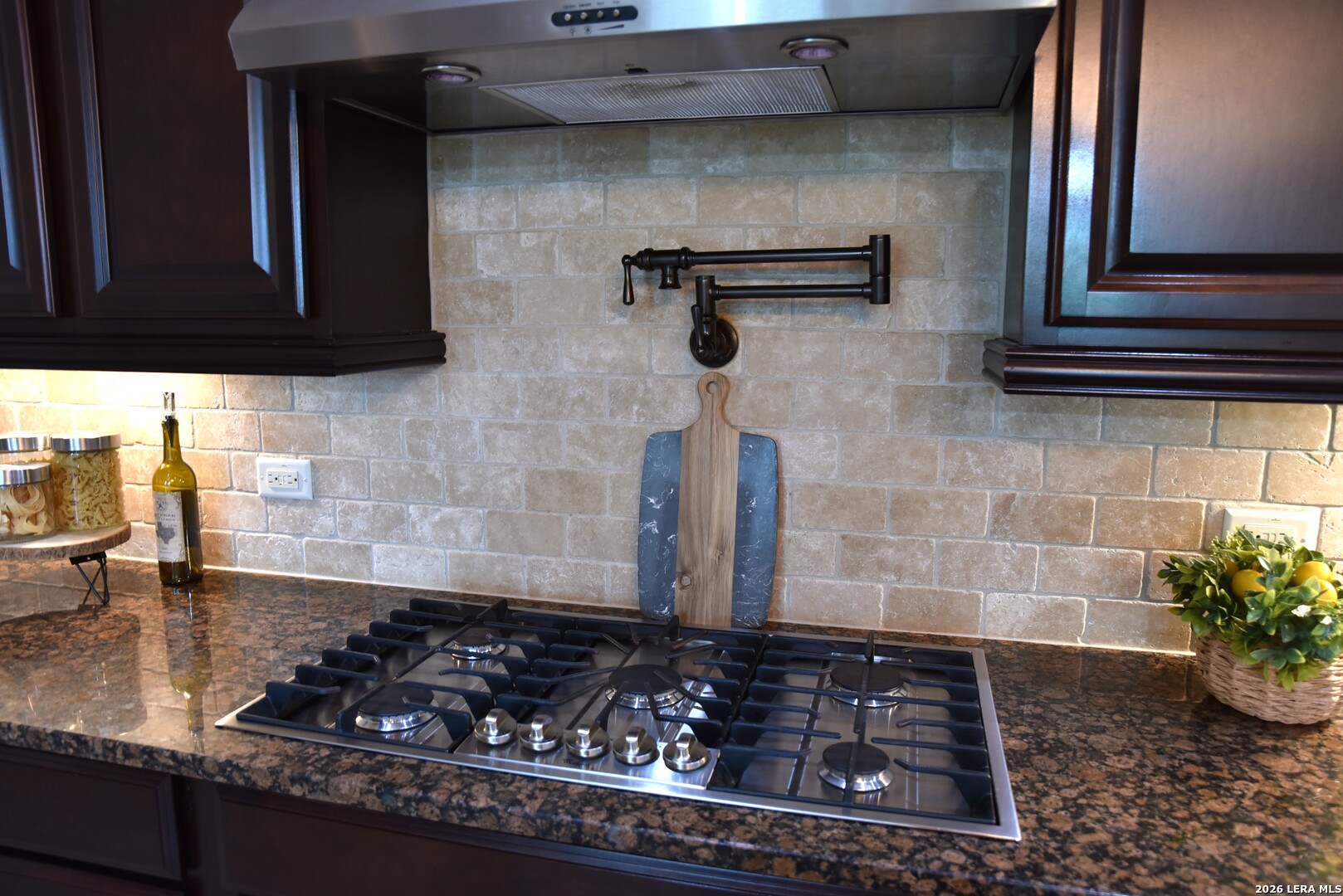 8907 Irving Hill Fair Oaks Ranch, TX 78015 - Photo 20 of 42 a bathroom with a granite countertop sink and a stove