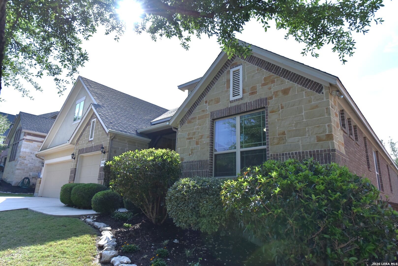 8907 Irving Hill Fair Oaks Ranch, TX 78015 - Photo 2 of 42 a brick house with potted plants in front of it