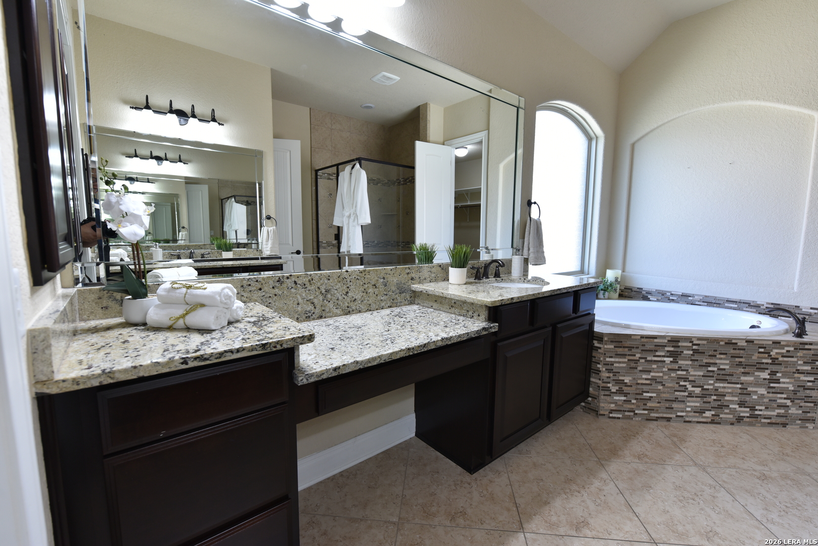 8907 Irving Hill Fair Oaks Ranch, TX 78015 - Photo 33 of 42 a bathroom with a granite countertop double vanity sink and a mirror
