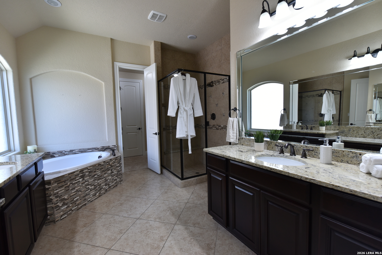 8907 Irving Hill Fair Oaks Ranch, TX 78015 - Photo 34 of 42 a bathroom with a double vanity sink and a mirror
