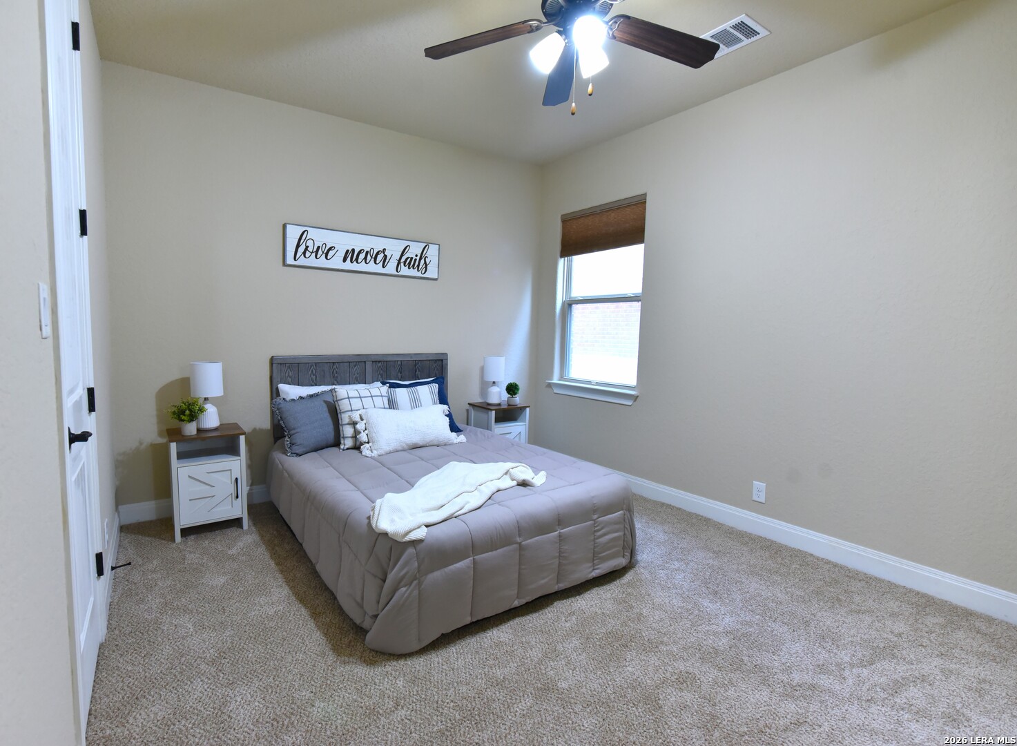 8907 Irving Hill Fair Oaks Ranch, TX 78015 - Photo 37 of 42 a spacious bedroom with a bed and a chandelier
