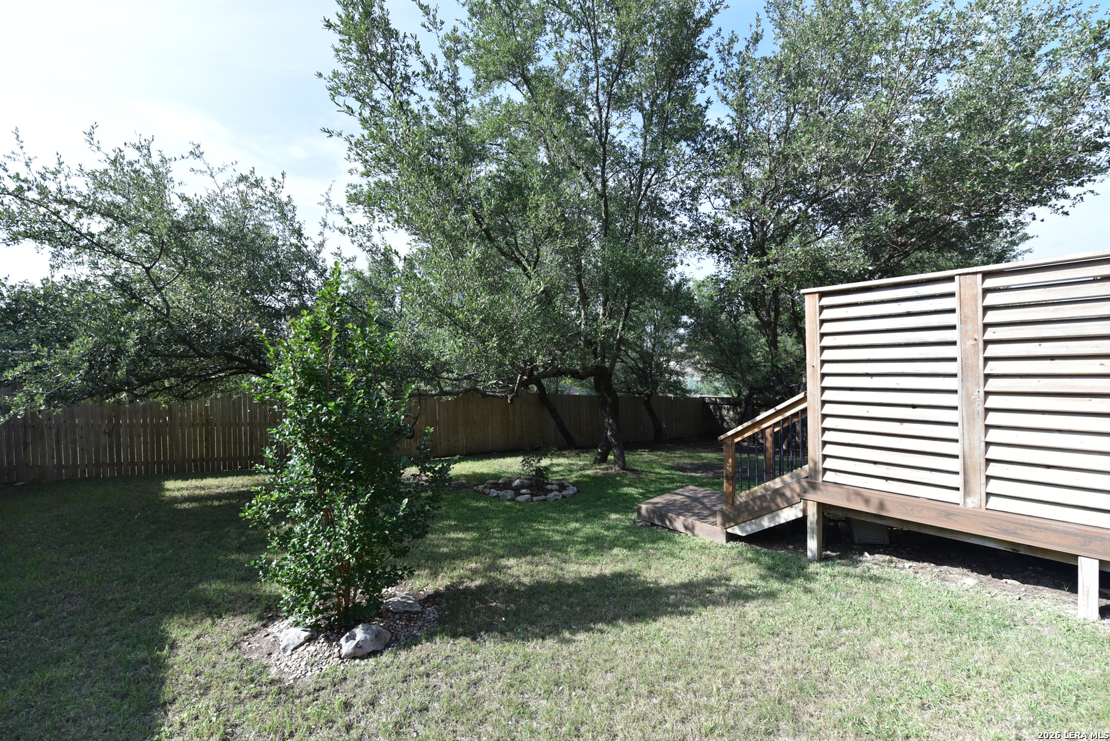 8907 Irving Hill Fair Oaks Ranch, TX 78015 - Photo 41 of 42 a view of a backyard with plants and a tree