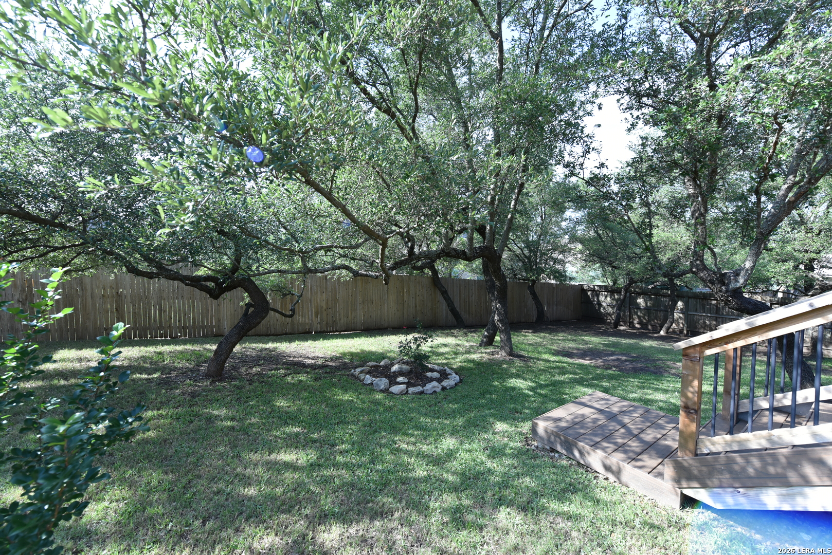 8907 Irving Hill Fair Oaks Ranch, TX 78015 - Photo 42 of 42 a backyard of a house with table and chairs