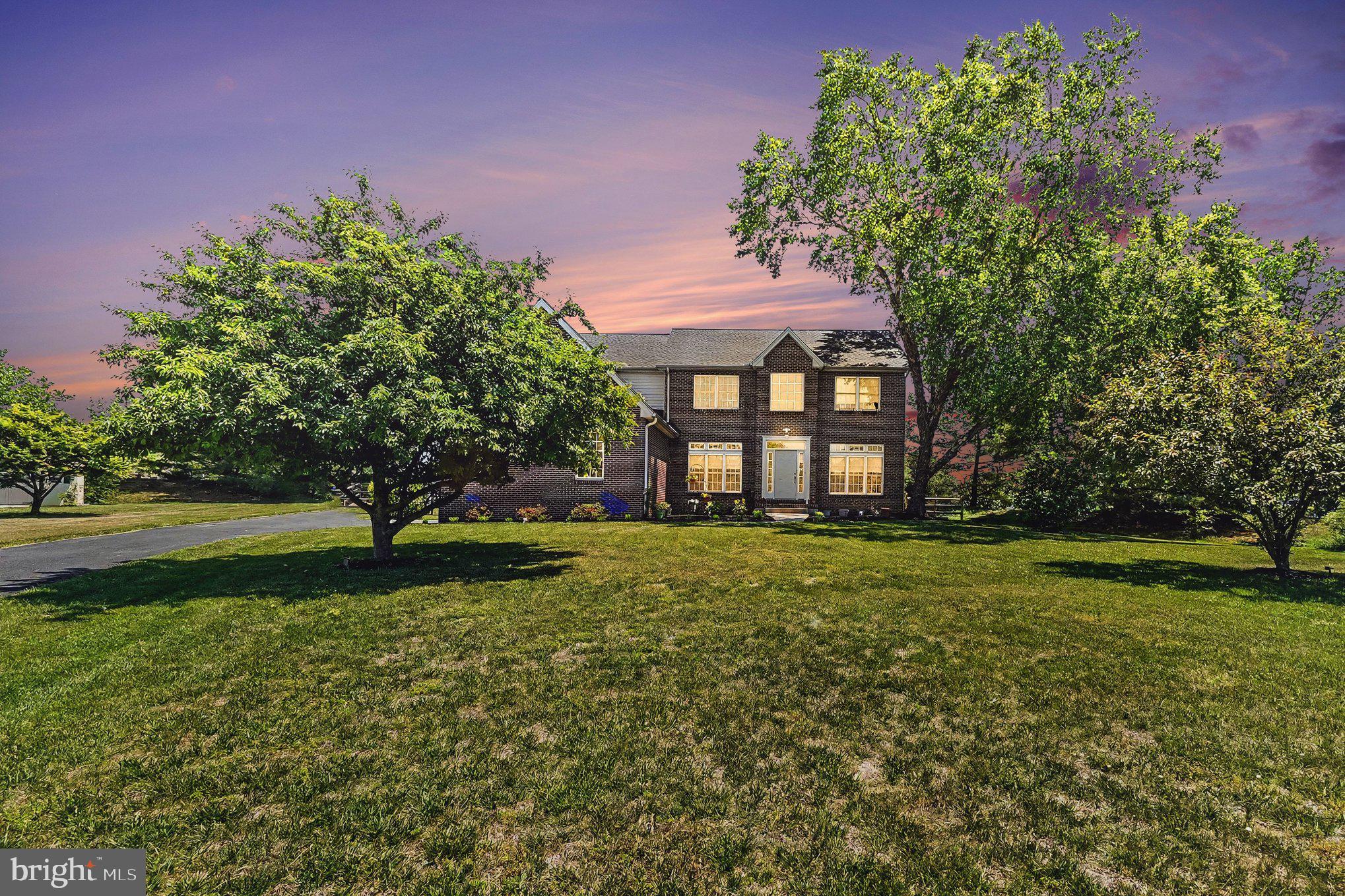 64 Open Meadow Court Elkton, MD 21921 - Photo 2 of 57 a view of a house next to a big yard and large trees