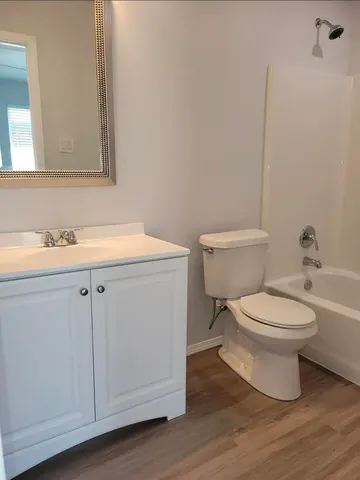 a white toilet sitting next to a bathroom sink