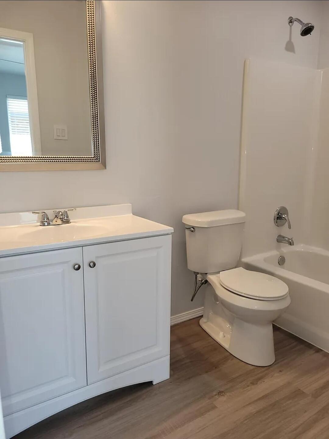 5524 Jarvis Street, Unit B Lubbock, TX 79416 - Photo 11 of 13 a white toilet sitting next to a bathroom sink