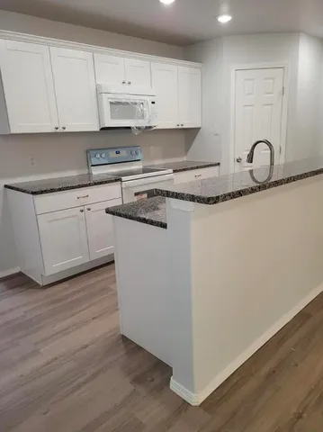 a kitchen with wooden cabinets and a sink