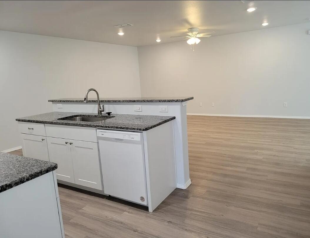 5524 Jarvis Street, Unit B Lubbock, TX 79416 - Photo 5 of 13 a kitchen with a sink vanity and stainless steel appliances