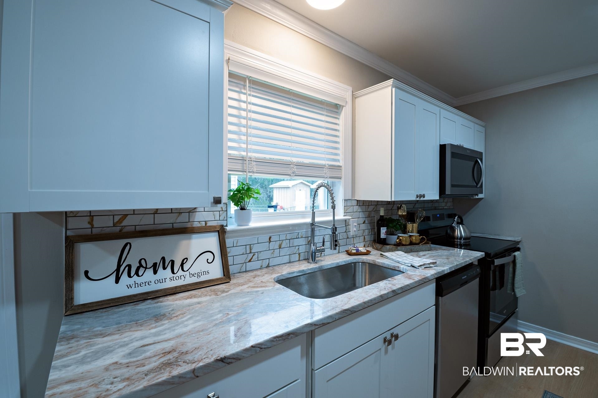 13474 Rooster Lane Foley, AL 36535 - Photo 4 of 39 Kitchen featuring ornamental molding, a sink, white cabinetry, stainless steel appliances, and decorative backsplash