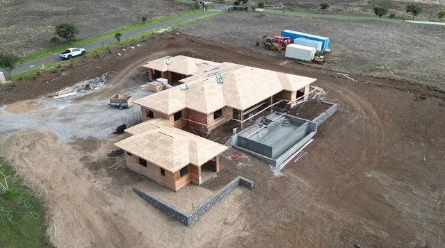 an aerial view of a house with a yard and lake view