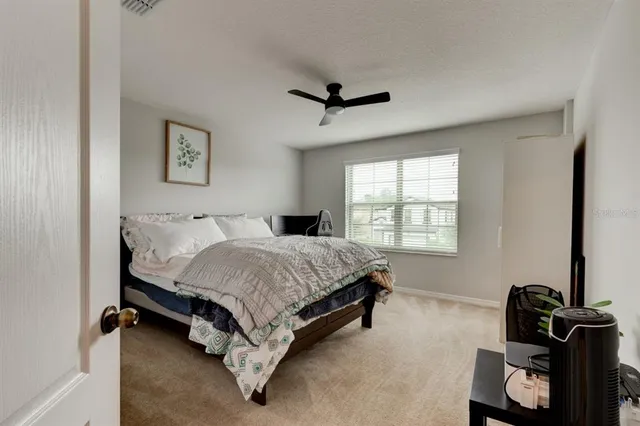 a bed sitting in a bedroom next to a window