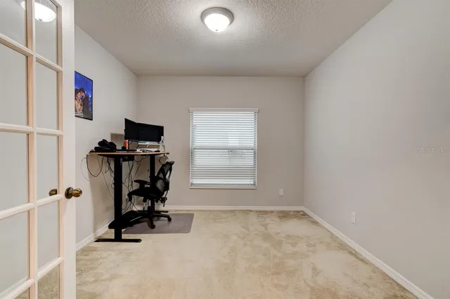 a view of workspace with gym equipment and a window