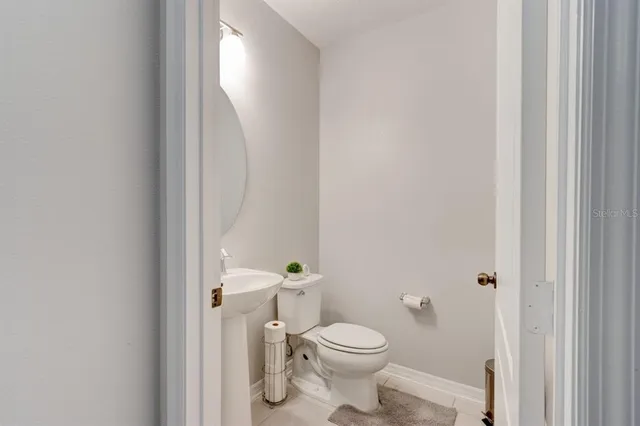 a white toilet sitting next to a shower