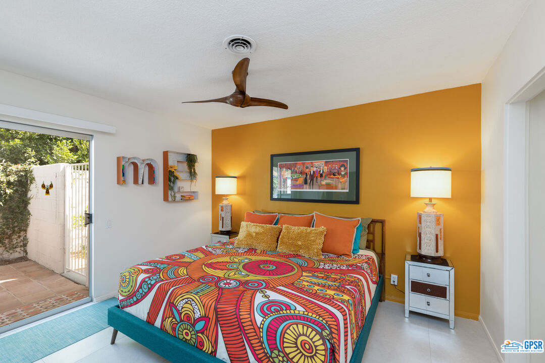 1655 Andee Drive Palm Springs, CA 92264 - Photo 15 of 23 a bedroom with a bed and a painting on the wall