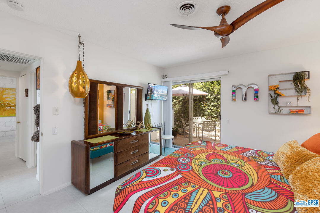 1655 Andee Drive Palm Springs, CA 92264 - Photo 16 of 23 a bedroom with furniture and a window