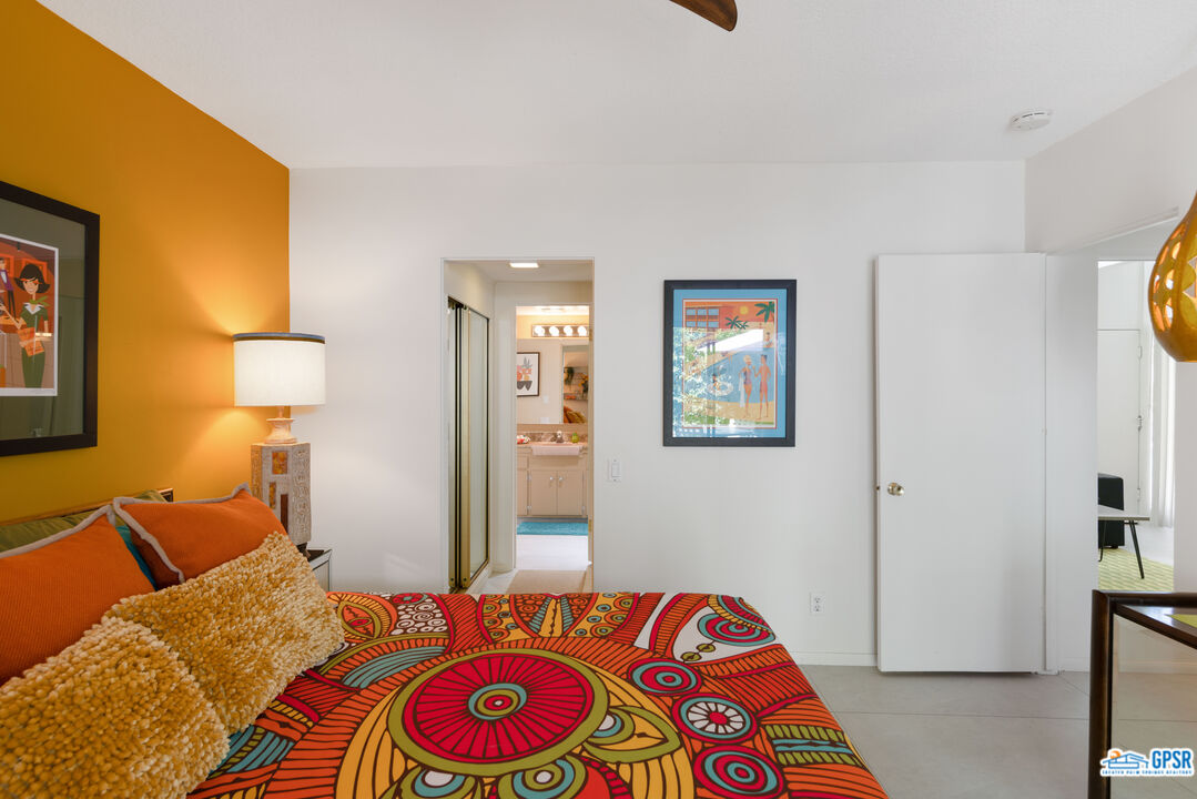 1655 Andee Drive Palm Springs, CA 92264 - Photo 17 of 23 a bedroom with a bed and a lamp on dresser