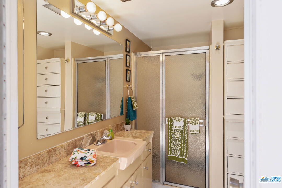 1655 Andee Drive Palm Springs, CA 92264 - Photo 18 of 23 a bathroom with a granite countertop sink and a mirror