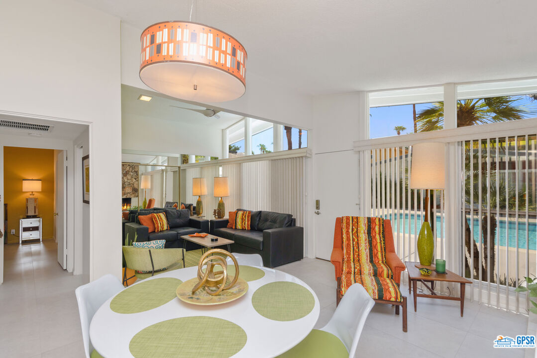 1655 Andee Drive Palm Springs, CA 92264 - Photo 4 of 23 a dining room with furniture a rug and wooden floor