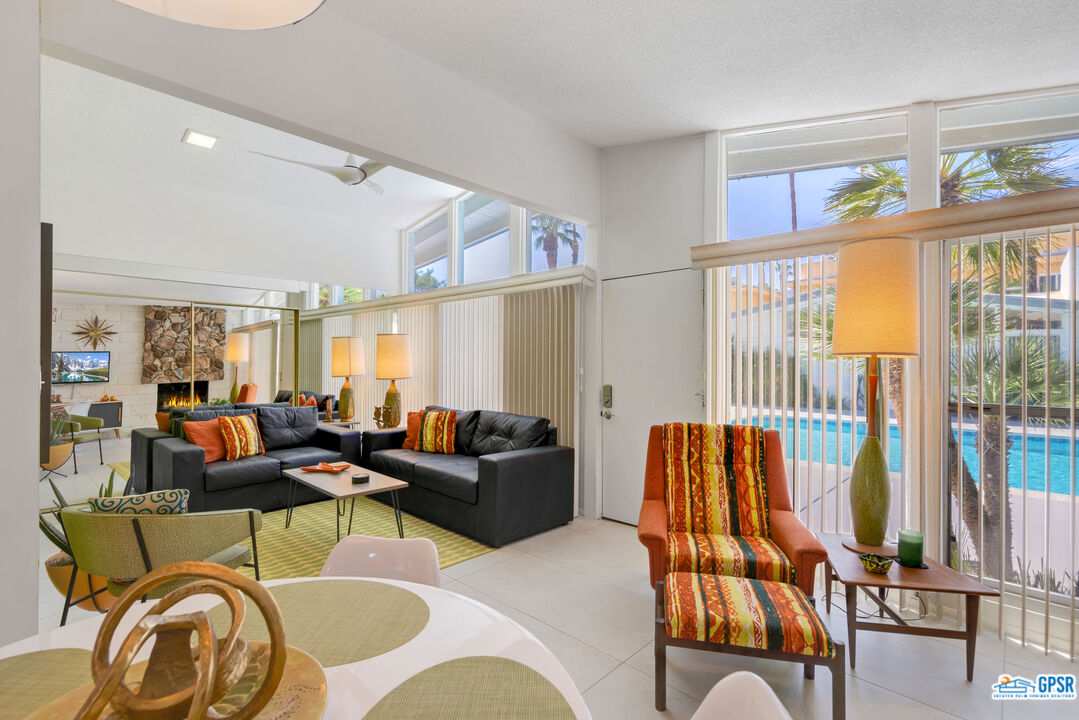 1655 Andee Drive Palm Springs, CA 92264 - Photo 9 of 23 a living room with furniture and a floor to ceiling window