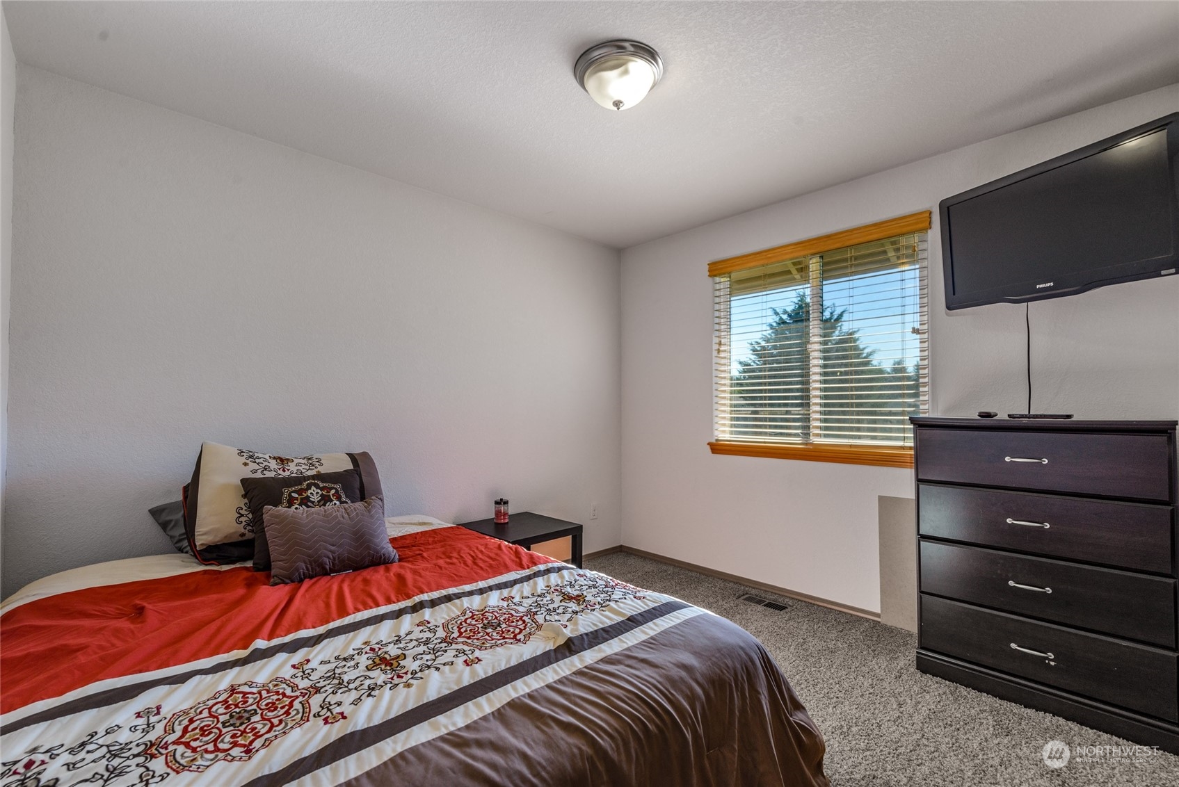 17914 Michelles Lane Southwest Rochester, WA 98579 - Photo 11 of 28 a bedroom with a bed and flat screen tv