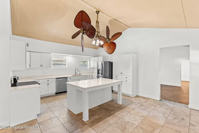 a kitchen with a stove cabinets and a refrigerator